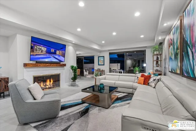 a living room with furniture and a potted plant