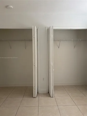 a view of room with walk in closet and window