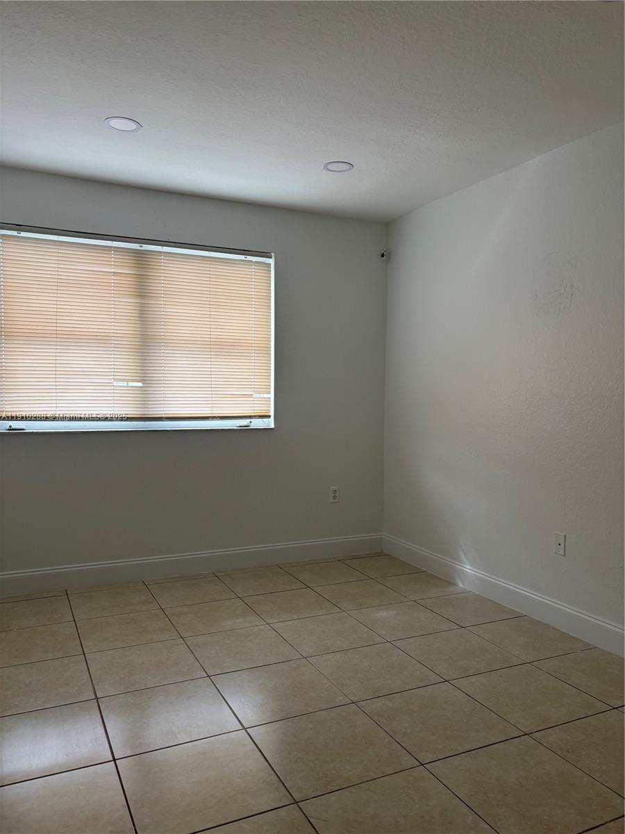 17710 Northwest 73rd Avenue, Unit 20220 Hialeah, FL 33015 - Photo 5 of 16 an empty room with a window