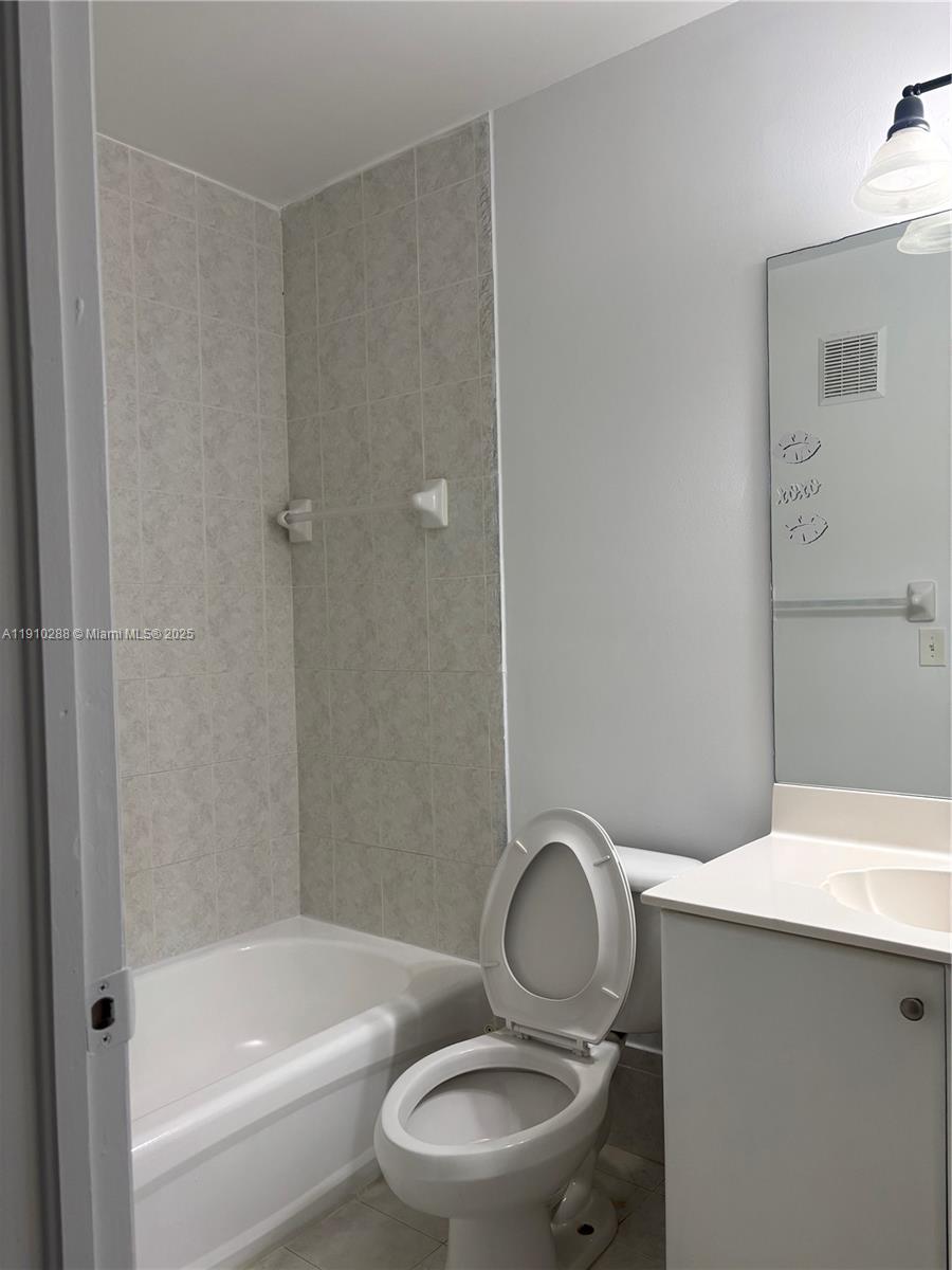 17710 Northwest 73rd Avenue, Unit 20220 Hialeah, FL 33015 - Photo 8 of 16 a bathroom with a sink toilet and shower