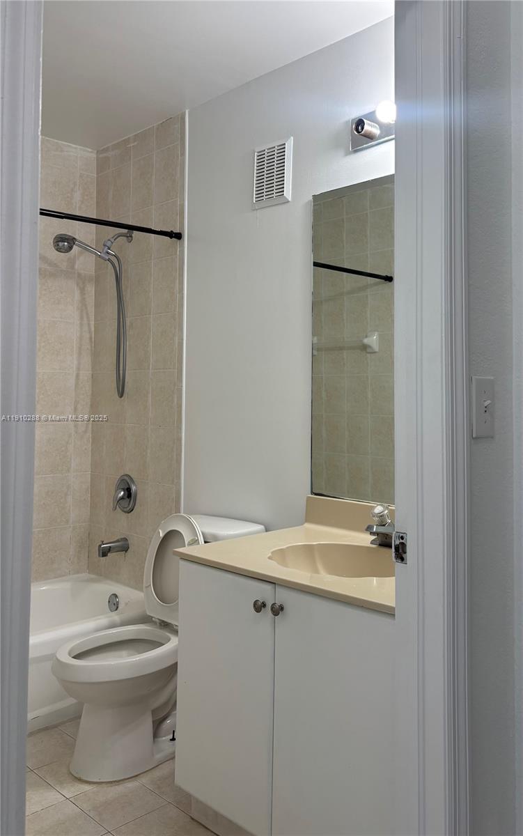 17710 Northwest 73rd Avenue, Unit 20220 Hialeah, FL 33015 - Photo 9 of 16 a bathroom with a granite countertop sink toilet and shower