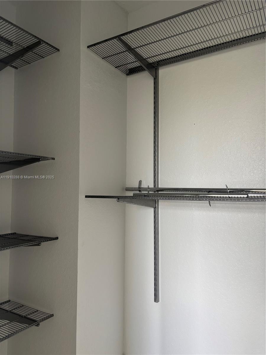 17710 Northwest 73rd Avenue, Unit 20220 Hialeah, FL 33015 - Photo 10 of 16 a view of walk in closet with empty racks