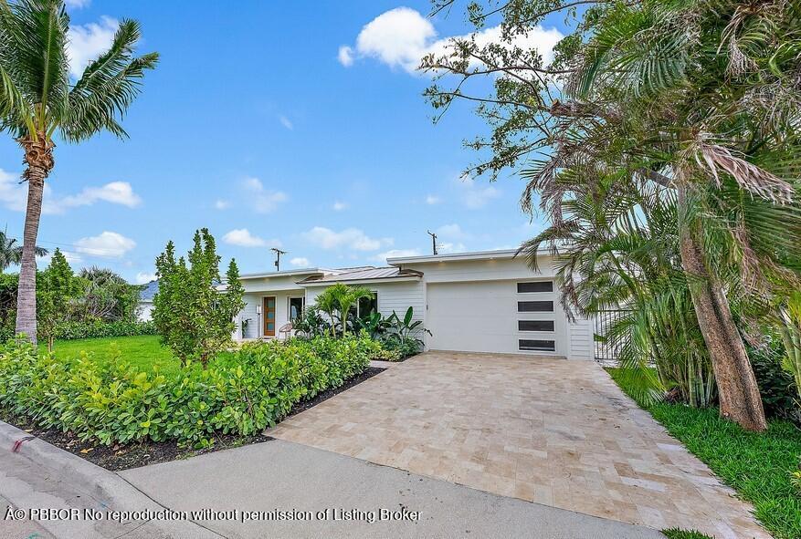 310 Edmor Road West Palm Beach, FL 33405 - Photo 1 of 32 a front view of a house with a yard and potted plants
