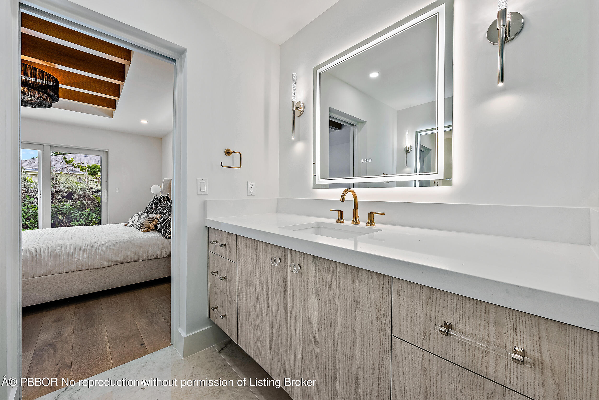 310 Edmor Road West Palm Beach, FL 33405 - Photo 19 of 32 a en suite bathroom with a double vanity sink and a mirror