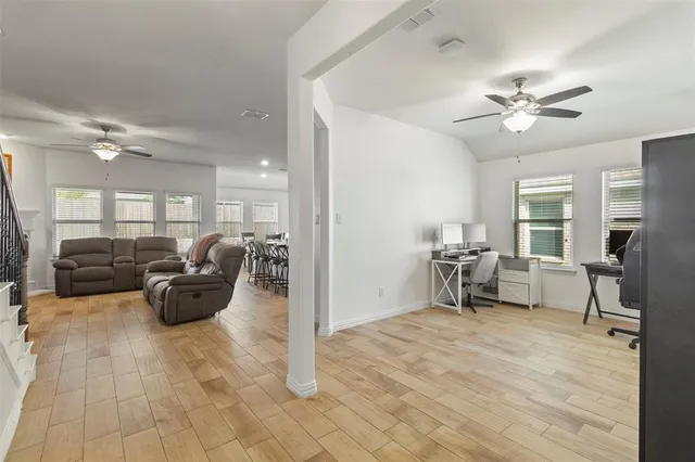 a view of a livingroom with a furniture and a ceiling fan