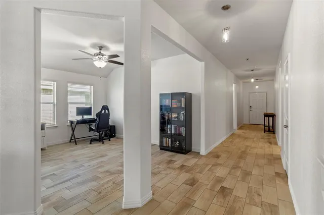 a living room with furniture a chandelier and a window