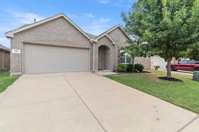a front view of a house with a garden and plants