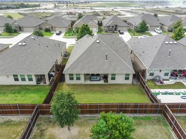 an aerial view of residential houses with outdoor space