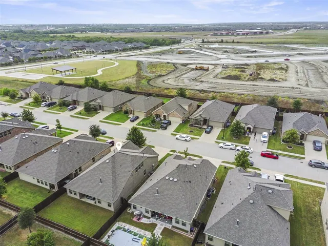 an aerial view of a house with a swimming pool yard and outdoor seating