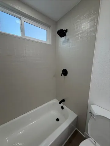 a bathroom with a bathtub and toilet