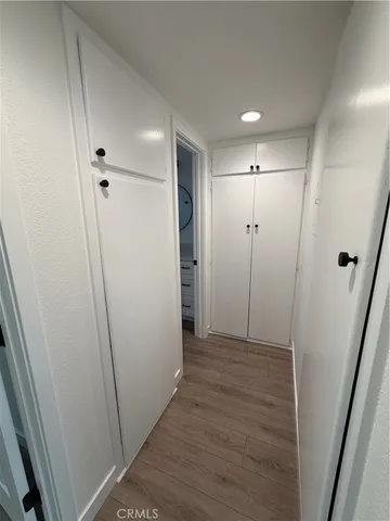 a view of hallway with wooden floor