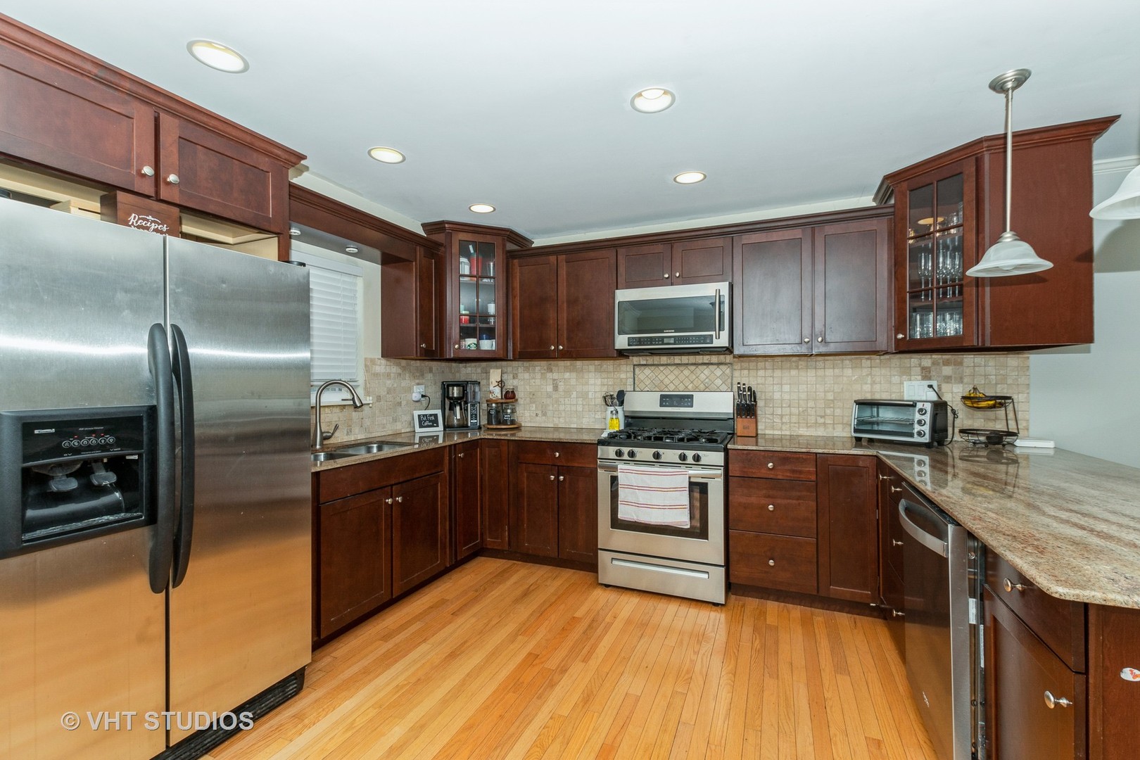 2149 Downey Road Homewood, IL 60430 - Photo 3 of 19 a kitchen with stainless steel appliances granite countertop wooden cabinets a stove a sink and a refrigerator