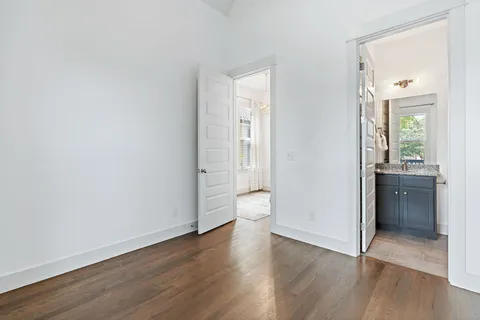 wooden floor in an empty room and a kitchen