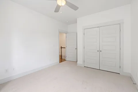 an empty room with a empty space and a ceiling fan