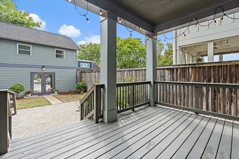 a view of a house with wooden floor next to a yard