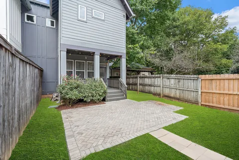 a view of house with backyard and garden