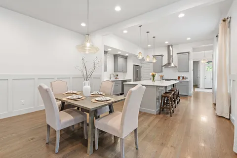 a large kitchen with a table and chairs