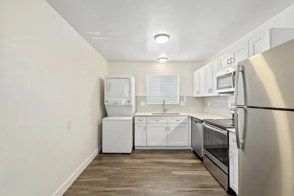 a kitchen with a refrigerator sink and stove