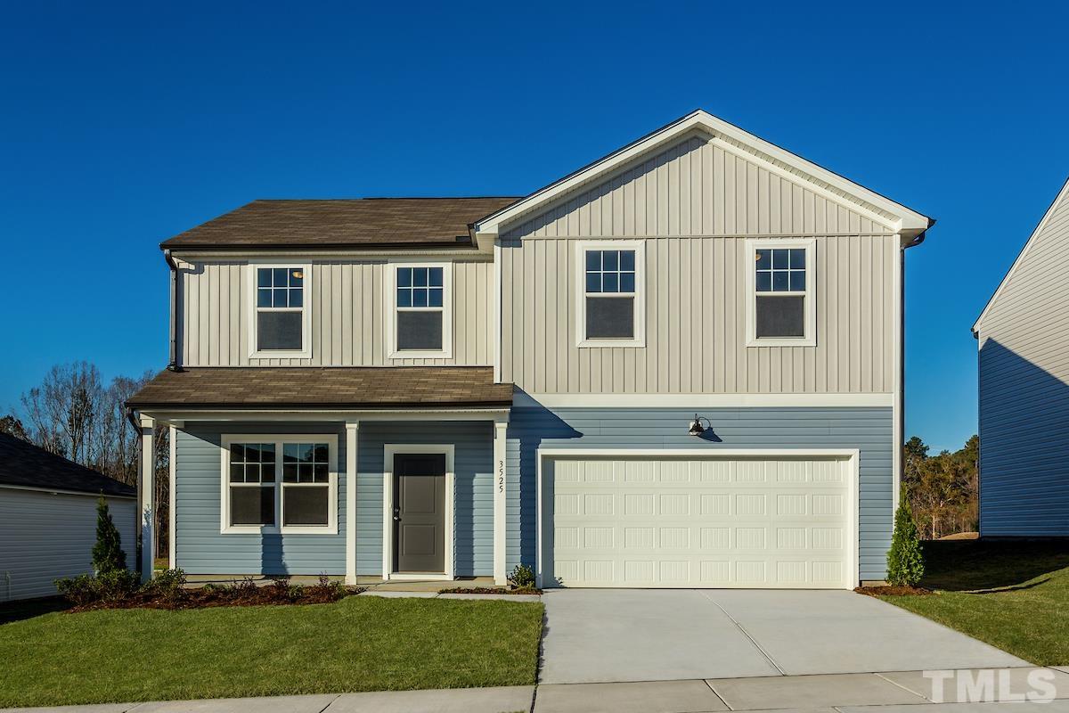 1721 Luna Way Raleigh, NC 27604 - Photo 2 of 27 a front view of a house with a garden and garage