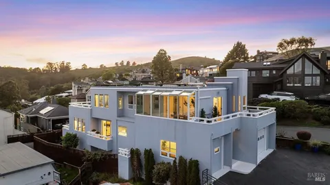 a aerial view of a house with a yard garage and a street