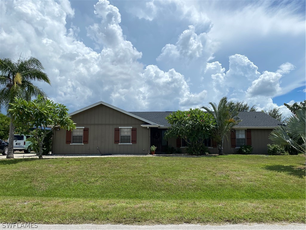 a front view of house with yard and green space