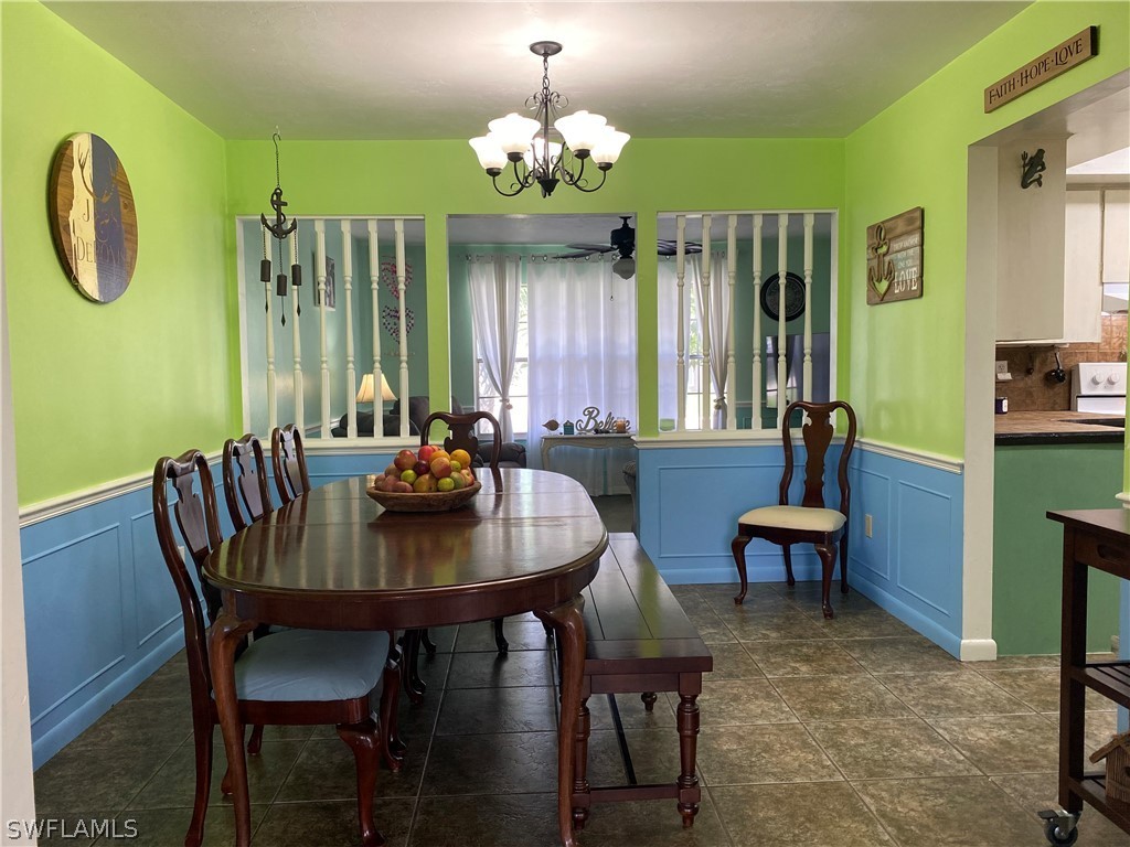 7334 Jonas Road Fort Myers, FL 33967 - Photo 12 of 29 a view of a dining room with furniture window and wooden floor