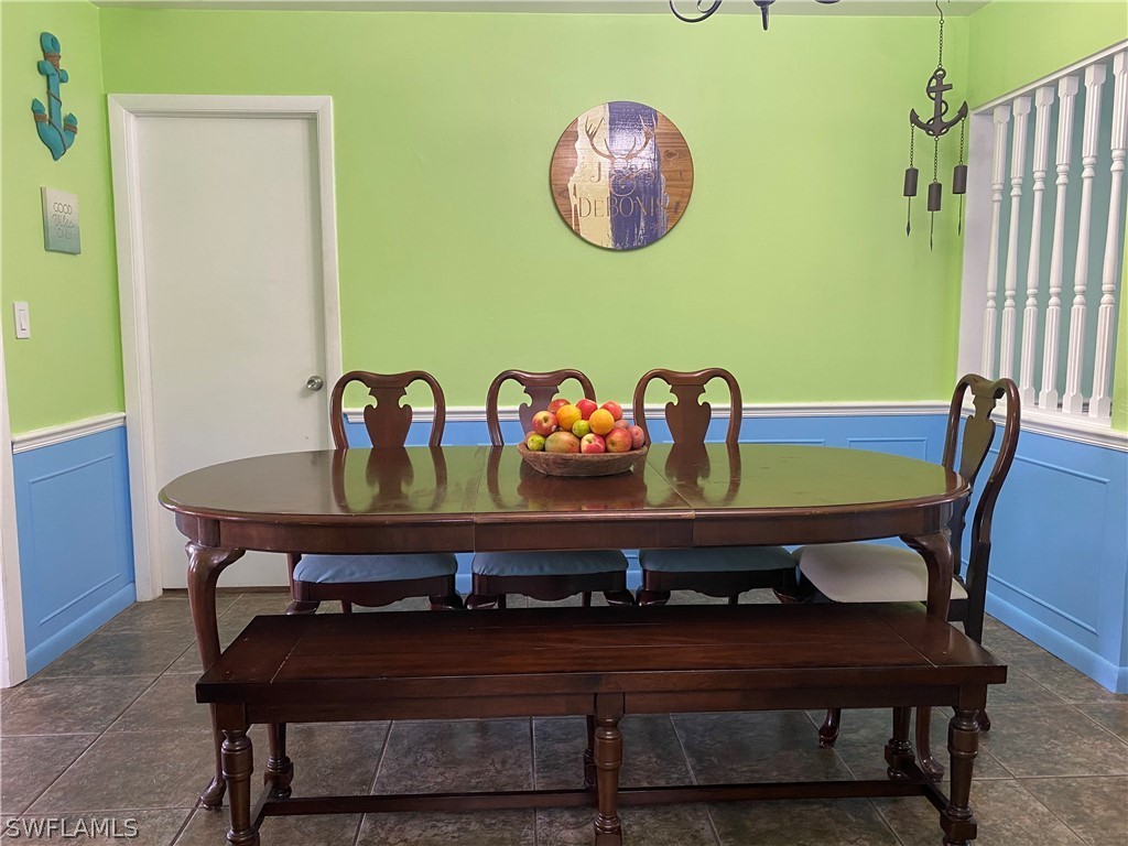 7334 Jonas Road Fort Myers, FL 33967 - Photo 13 of 29 a view of a dining room with furniture and chandelier