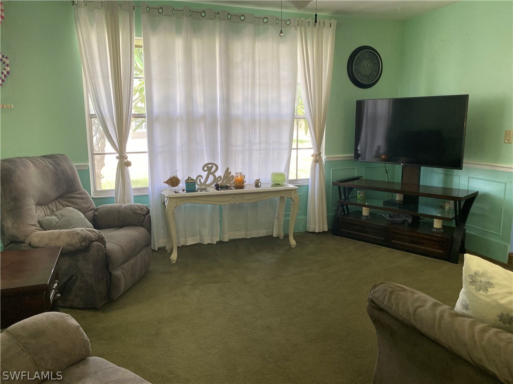 7334 Jonas Road Fort Myers, FL 33967 - Photo 15 of 29 a living room with furniture and a flat screen tv