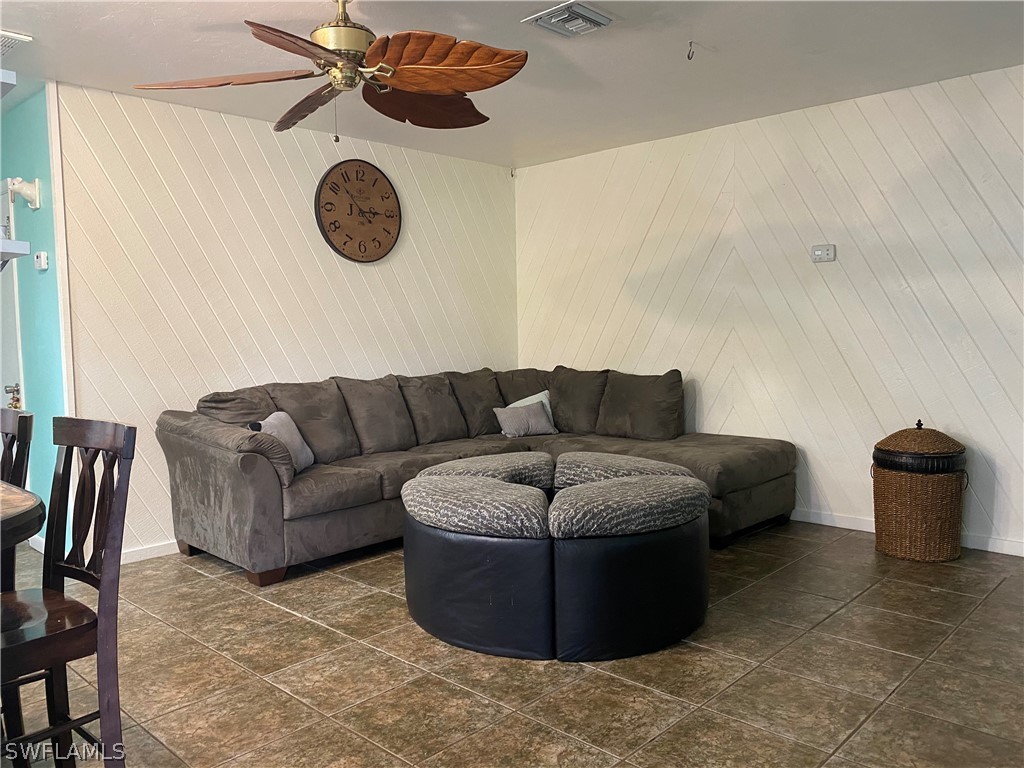 7334 Jonas Road Fort Myers, FL 33967 - Photo 16 of 29 a living room with furniture and a mirror