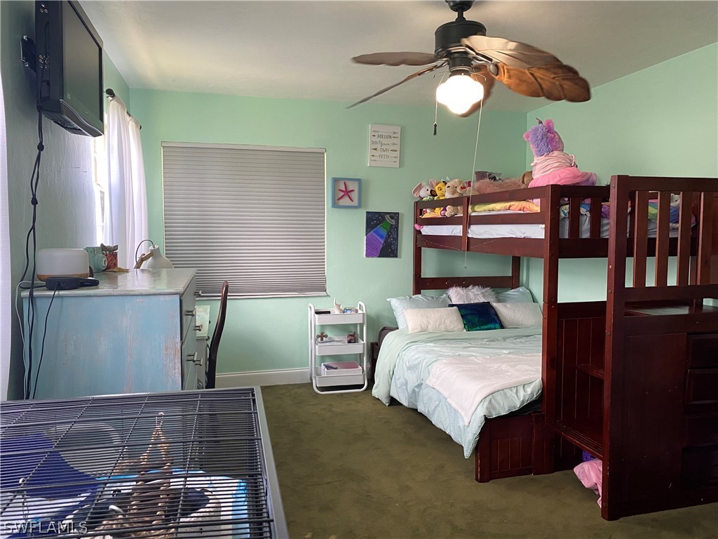 7334 Jonas Road Fort Myers, FL 33967 - Photo 20 of 29 a bedroom with a bed and a chandelier