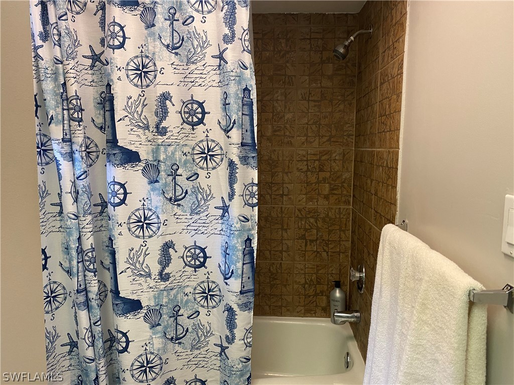 7334 Jonas Road Fort Myers, FL 33967 - Photo 22 of 29 a bathroom with a shower and a bathtub