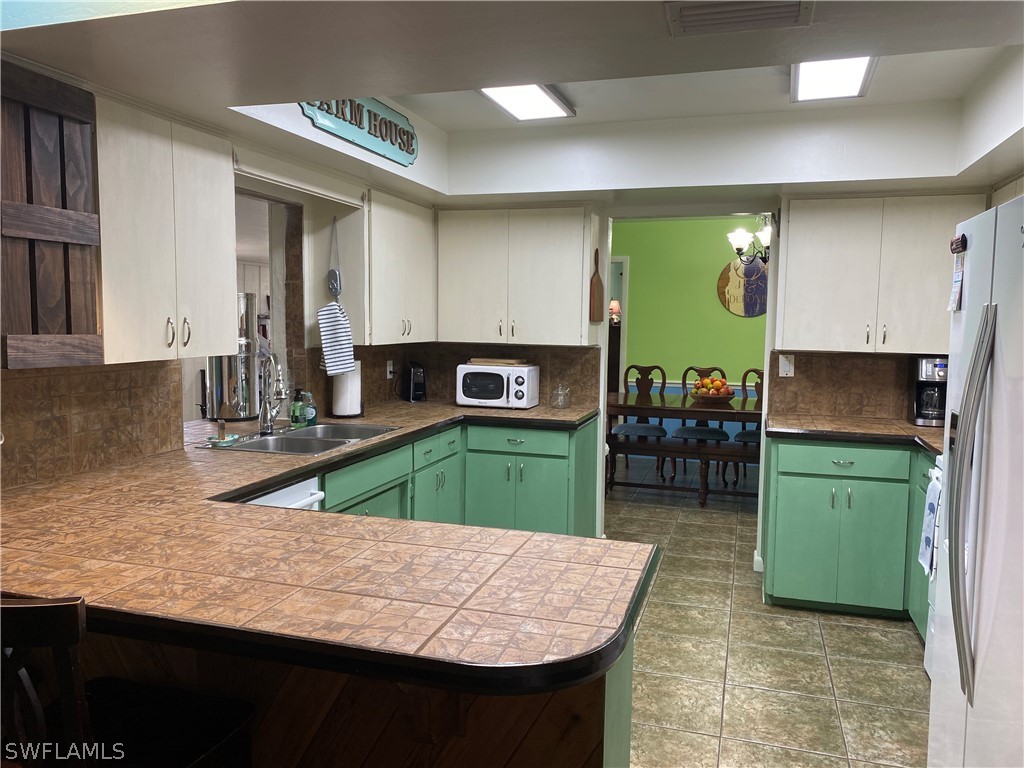 7334 Jonas Road Fort Myers, FL 33967 - Photo 25 of 29 a kitchen with a sink cabinets and wooden floor