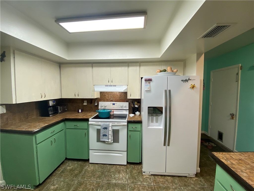 7334 Jonas Road Fort Myers, FL 33967 - Photo 27 of 29 a kitchen with a refrigerator sink and stove
