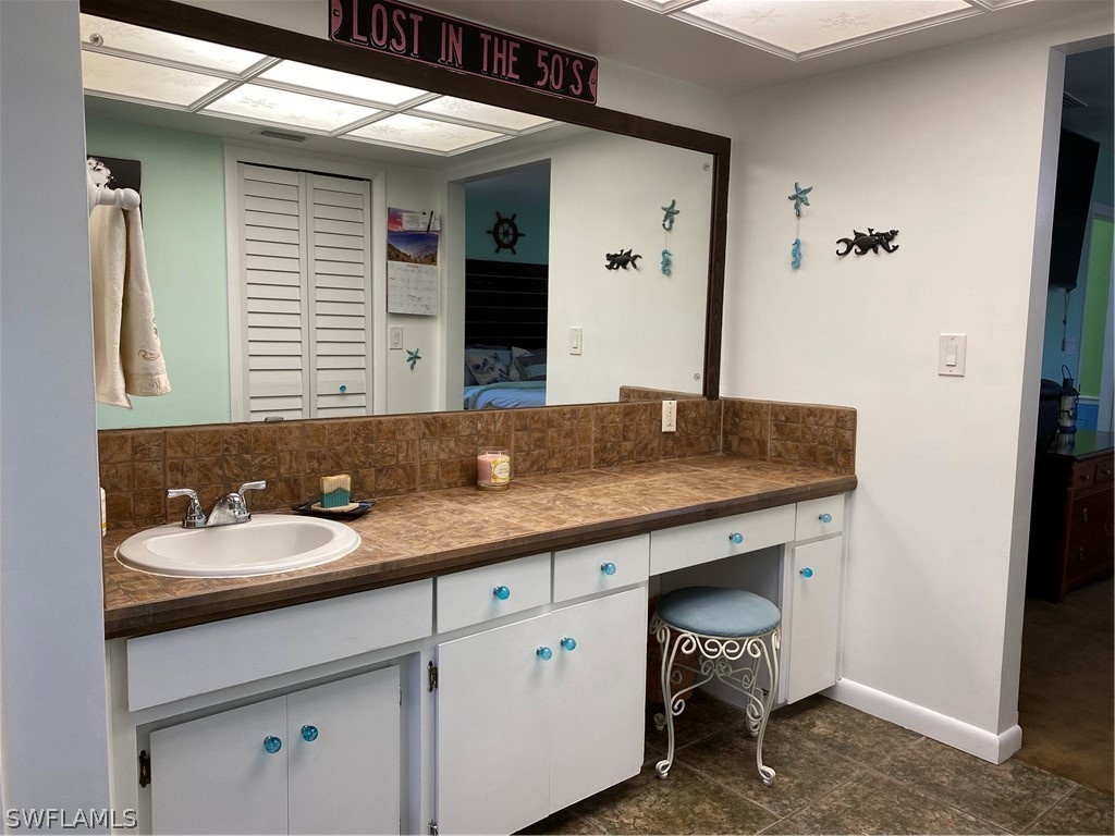 7334 Jonas Road Fort Myers, FL 33967 - Photo 28 of 29 a bathroom with a granite countertop sink and a mirror