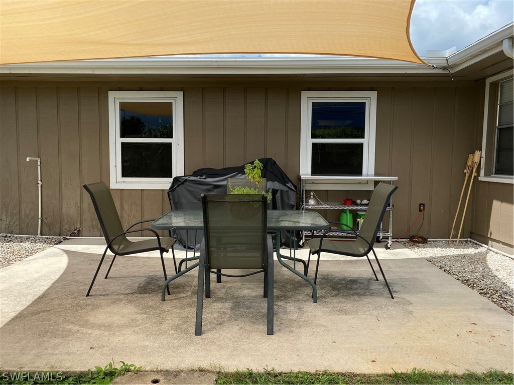 7334 Jonas Road Fort Myers, FL 33967 - Photo 4 of 29 a patio with table and chairs and potted plants