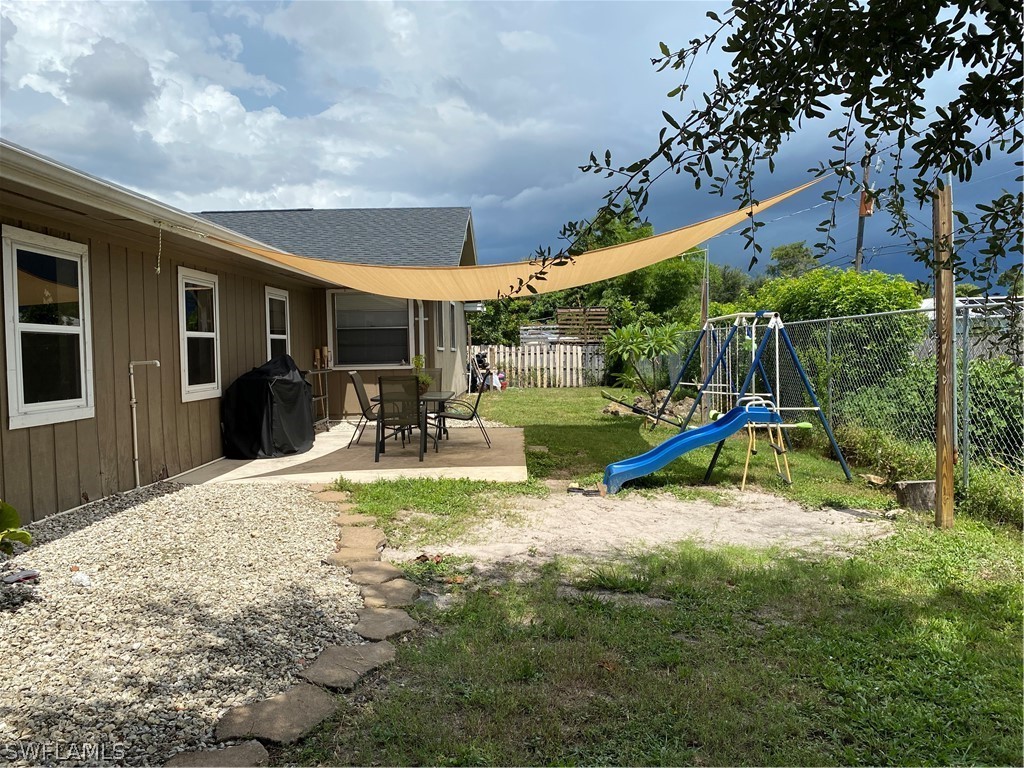 7334 Jonas Road Fort Myers, FL 33967 - Photo 7 of 29 a view of a house with backyard and a slide