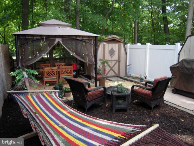 4813 Variation Road Nottingham, MD 21236 - Photo 12 of 30 a backyard of a house with barbeque oven and outdoor seating