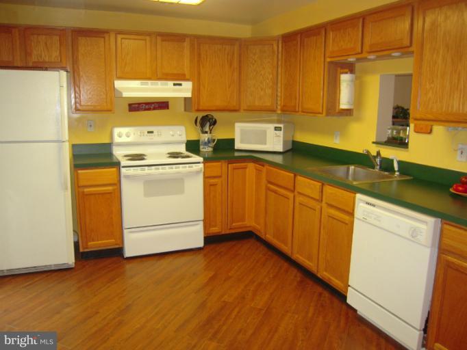 4813 Variation Road Nottingham, MD 21236 - Photo 15 of 30 a kitchen with a refrigerator sink and cabinets