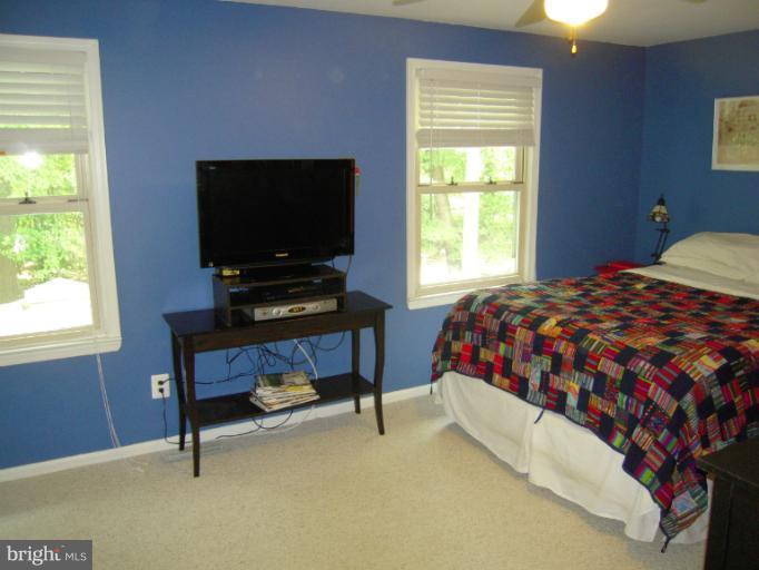 4813 Variation Road Nottingham, MD 21236 - Photo 16 of 30 a bedroom with a bed and a flat screen tv