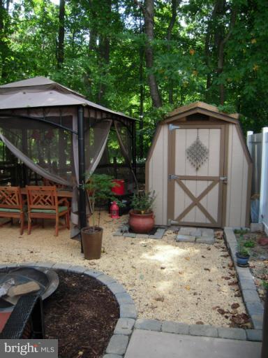 4813 Variation Road Nottingham, MD 21236 - Photo 21 of 30 a view of backyard with a table and chairs under an umbrella