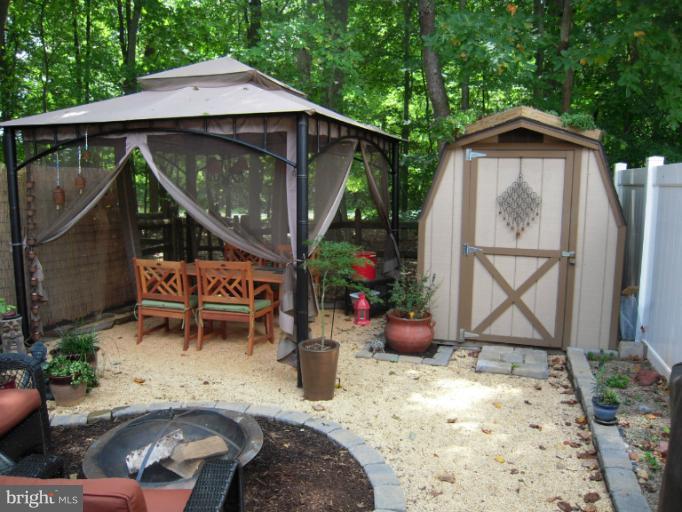 4813 Variation Road Nottingham, MD 21236 - Photo 29 of 30 a backyard of a house with wooden table and chairs