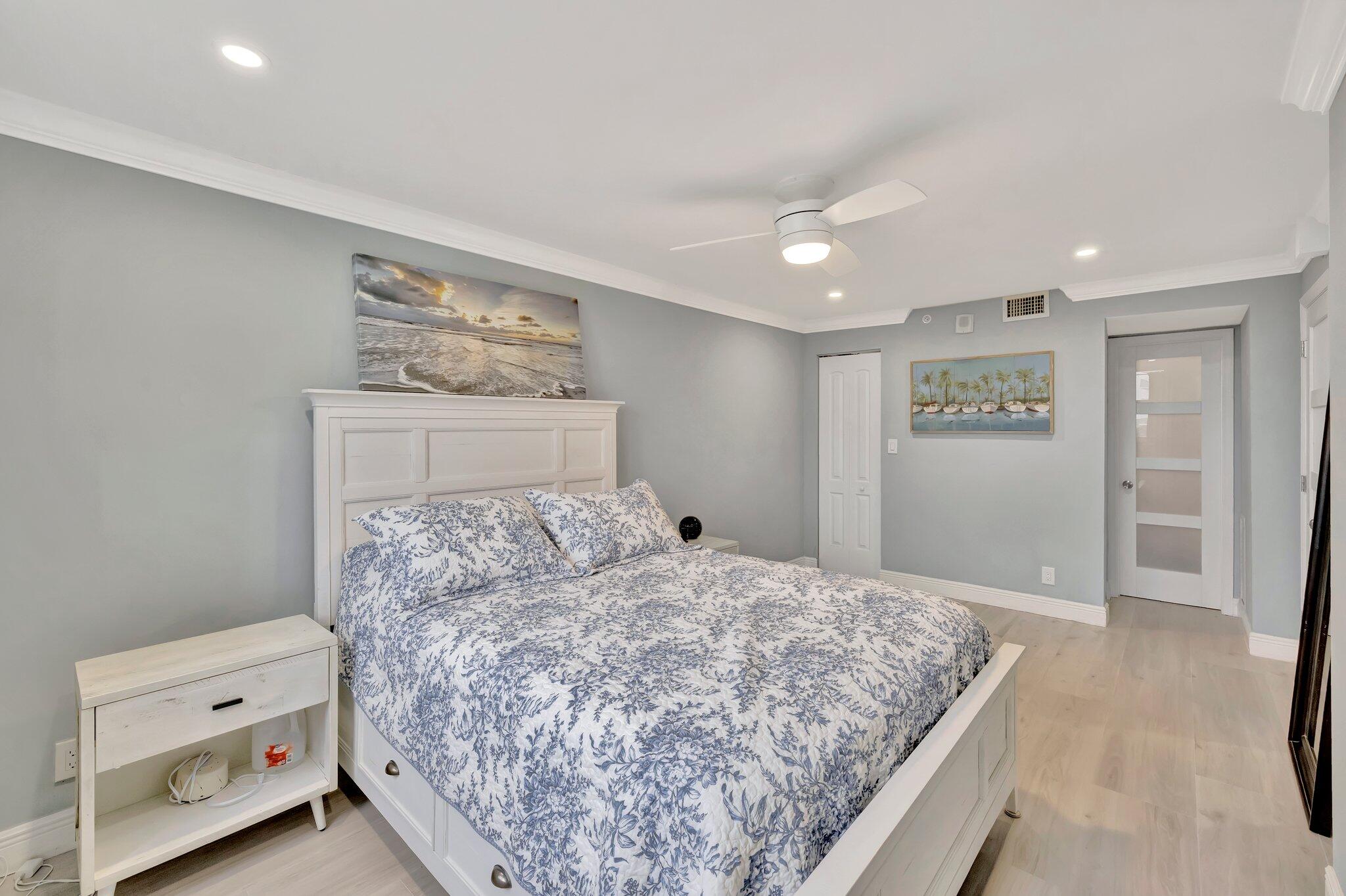 1505 North Riverside Drive, Unit 507 Pompano Beach, FL 33062 - Photo 14 of 39 a bedroom with a bed and painting on the wall