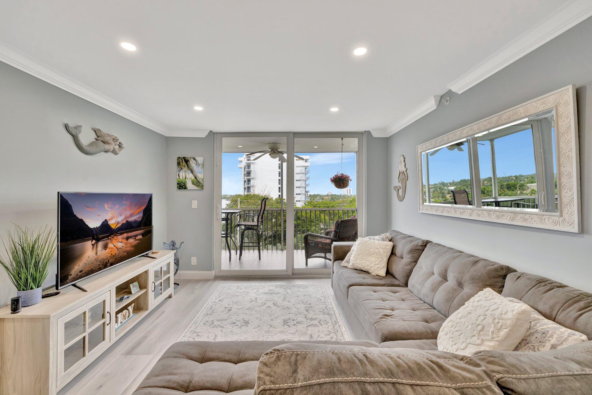 1505 North Riverside Drive, Unit 507 Pompano Beach, FL 33062 - Photo 20 of 39 a living room with furniture and a flat screen tv