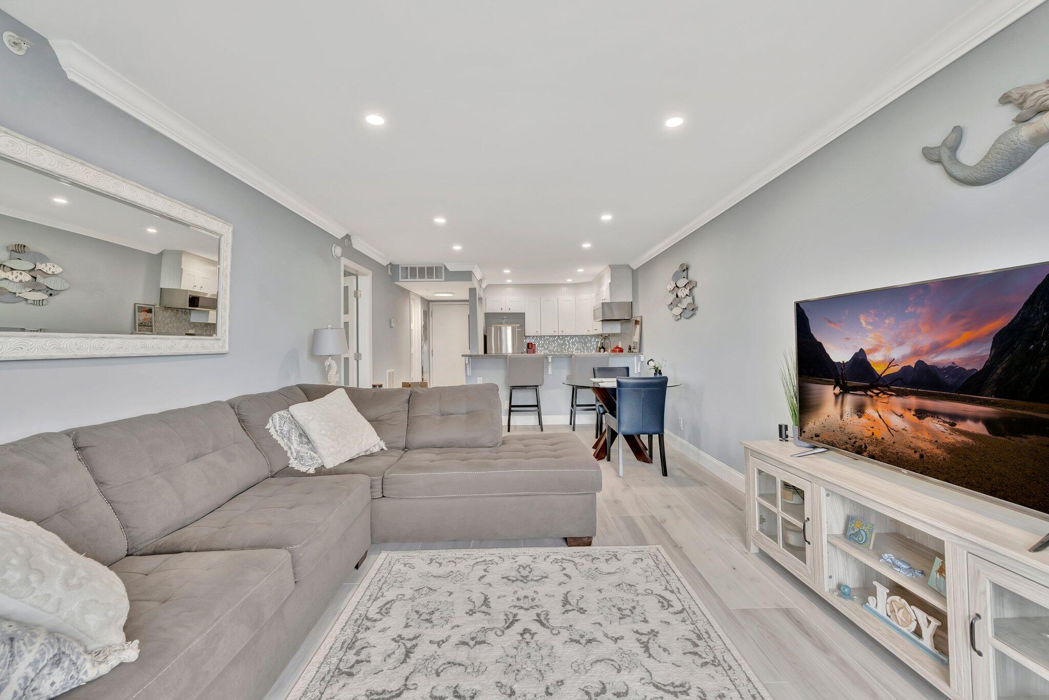 1505 North Riverside Drive, Unit 507 Pompano Beach, FL 33062 - Photo 9 of 39 a living room with furniture and a flat screen tv