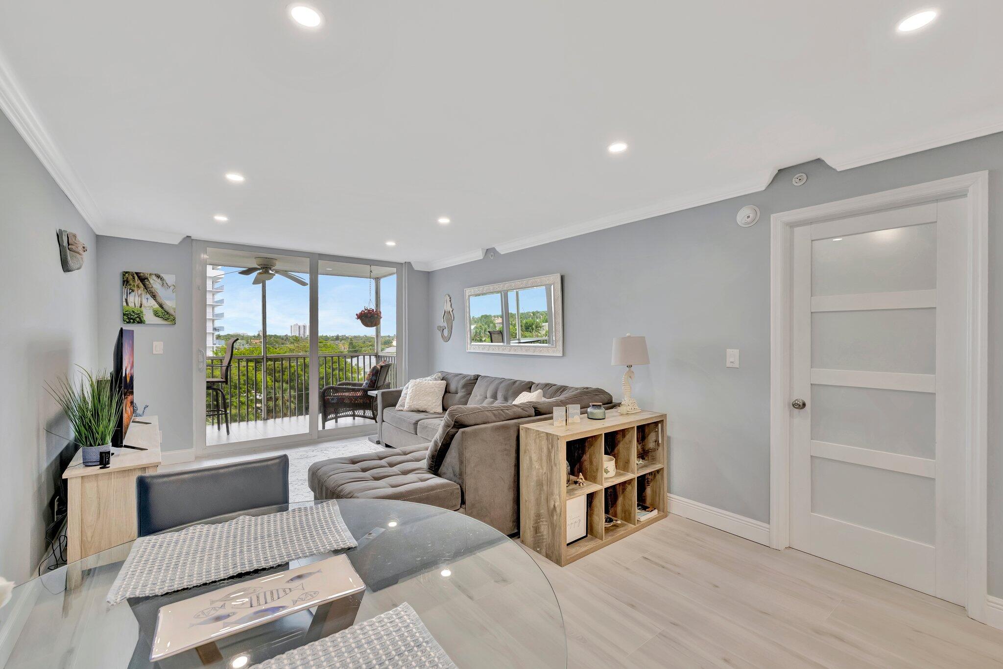 1505 North Riverside Drive, Unit 507 Pompano Beach, FL 33062 - Photo 10 of 39 a living room with furniture and a flat screen tv