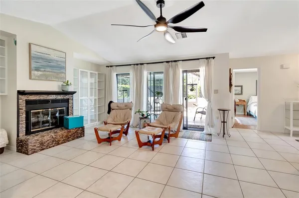 a living room with furniture a fireplace and a large window
