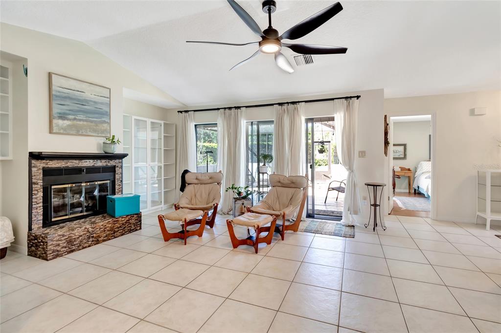 1908 Oak Circle Tavares, FL 32778 - Photo 11 of 28 a living room with furniture a fireplace and a large window