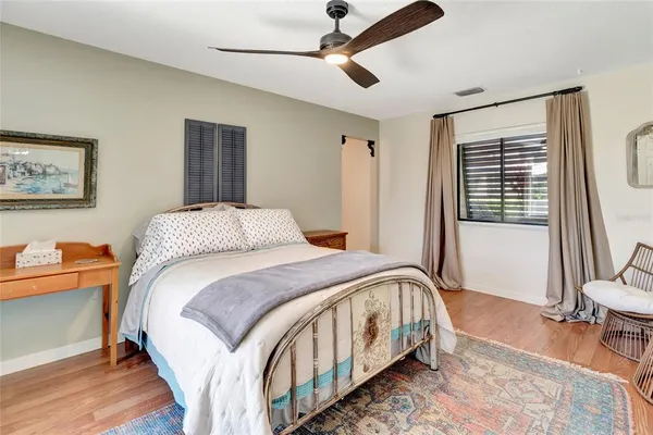 a bed sitting in a bedroom next to a window