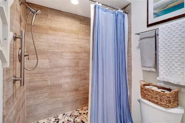 a bathroom with a shower and a sink