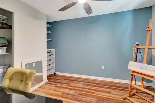 a bedroom with a bed and a chair